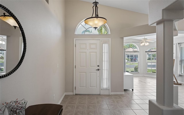 entryway with light tile patterned flooring, ceiling fan, and lofted ceiling