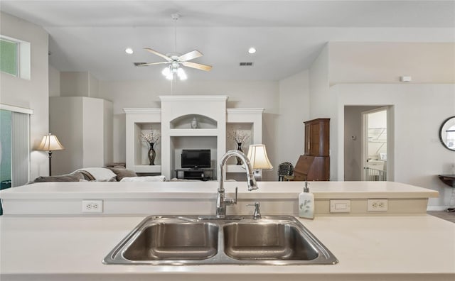 kitchen with lofted ceiling, sink, and ceiling fan