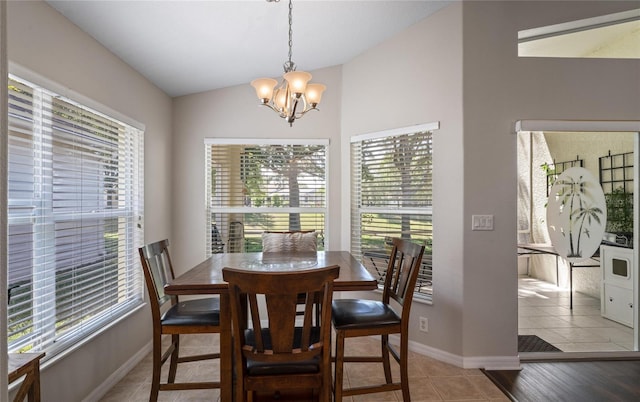 tiled dining room with vaulted ceiling and a notable chandelier