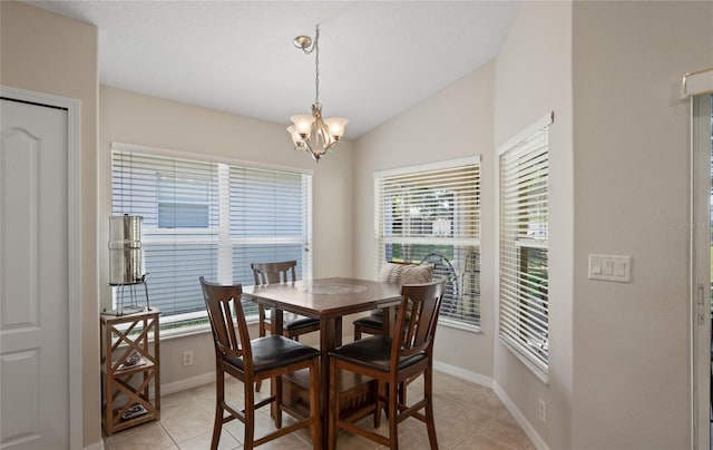 dining area featuring vaulted ceiling, light tile patterned flooring, and an inviting chandelier