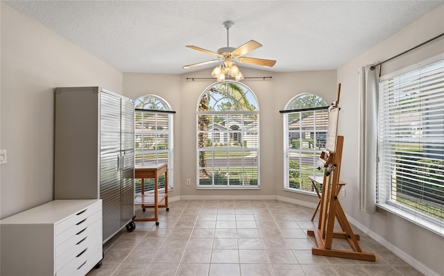 living area featuring ceiling fan, a wealth of natural light, and light tile patterned floors