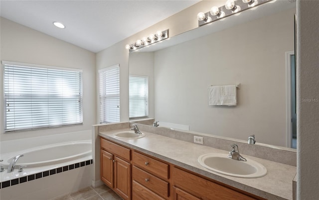 bathroom with vanity, lofted ceiling, a relaxing tiled tub, and tile patterned floors