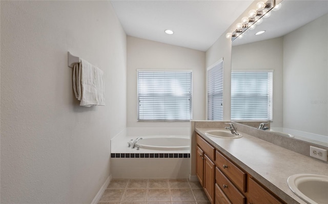 bathroom featuring vanity, vaulted ceiling, tile patterned floors, and tiled bath