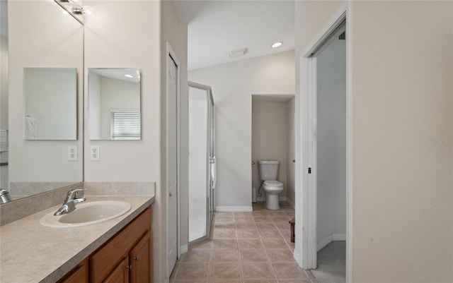 bathroom featuring vanity, tile patterned flooring, and toilet