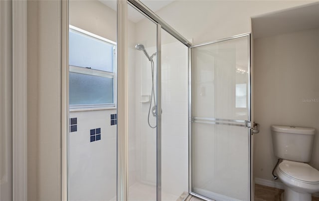 bathroom featuring an enclosed shower and toilet