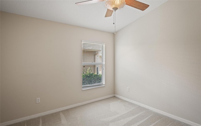 unfurnished room with lofted ceiling, carpet floors, and ceiling fan