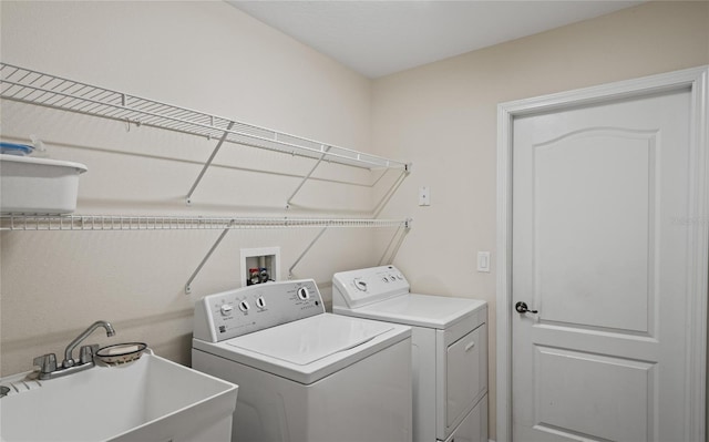 washroom featuring washing machine and clothes dryer and sink