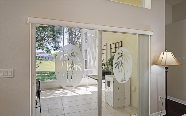 doorway to outside with light tile patterned floors