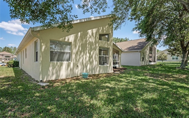 view of side of property featuring a yard