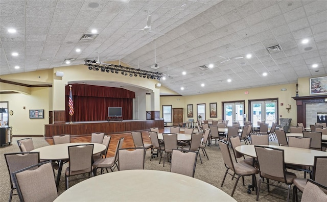 dining room featuring lofted ceiling, french doors, and carpet