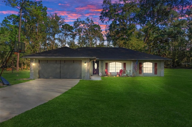 ranch-style house with a garage, brick siding, driveway, and a front lawn