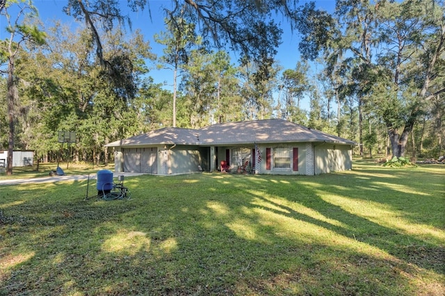 ranch-style house featuring a garage, a front lawn, and brick siding