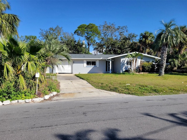 view of front of house with a garage and a front lawn