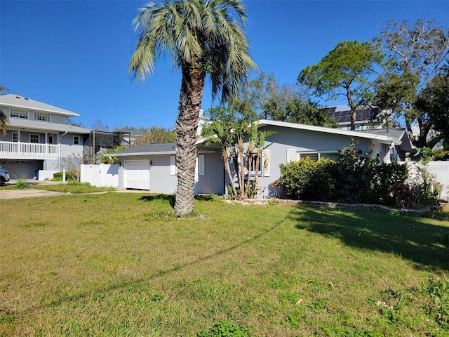 view of front of house with a garage and a front lawn