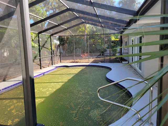 view of swimming pool featuring a lanai and a patio