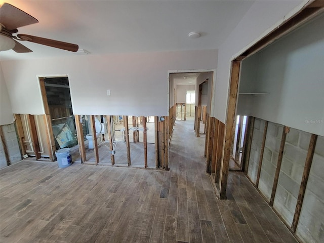 unfurnished room featuring dark wood-type flooring and ceiling fan