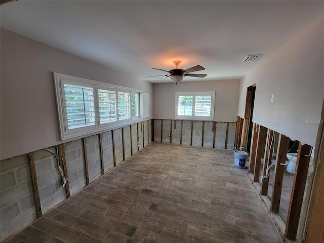 empty room with hardwood / wood-style floors and ceiling fan