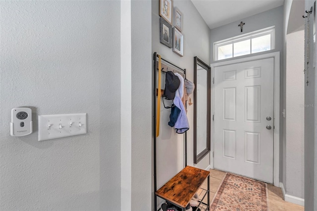 doorway to outside featuring light tile patterned flooring