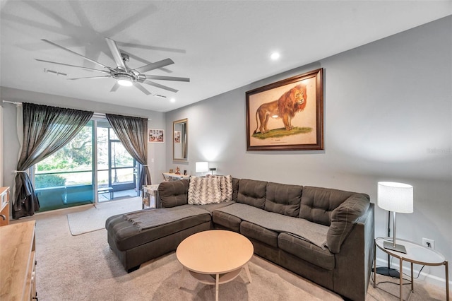 living room featuring light colored carpet and ceiling fan