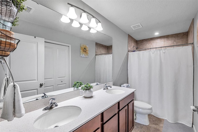 bathroom with tile patterned floors, toilet, a shower with curtain, a textured ceiling, and vanity