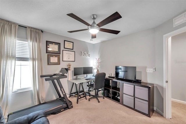 carpeted office space with ceiling fan