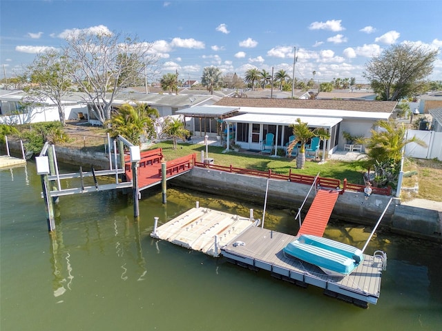 view of dock featuring a water view and a lawn