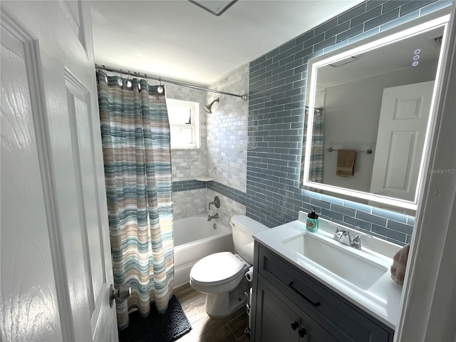 full bathroom with tile walls, decorative backsplash, vanity, toilet, and shower / bath combo with shower curtain