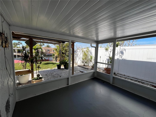 unfurnished sunroom featuring wood ceiling