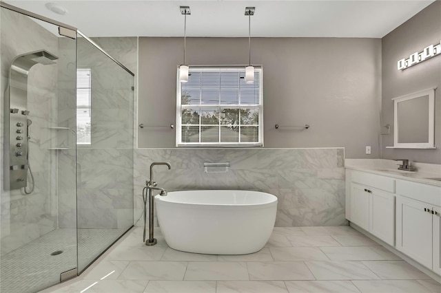 bathroom featuring vanity, plus walk in shower, and a wealth of natural light