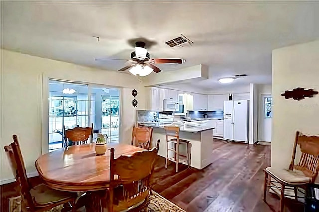 dining room featuring dark hardwood / wood-style flooring and ceiling fan