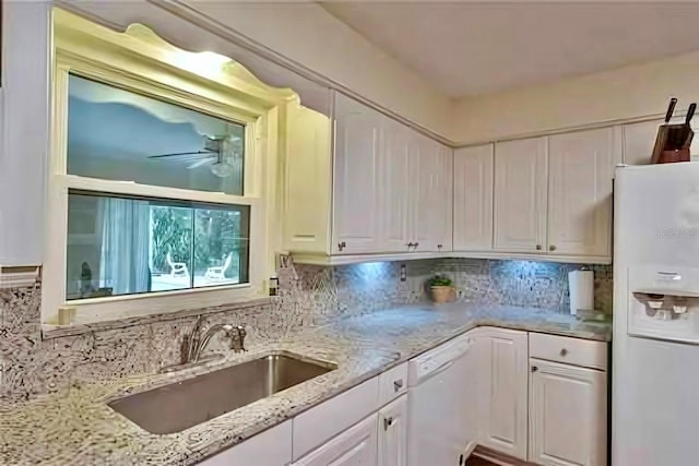 kitchen featuring white cabinetry, white appliances, sink, and decorative backsplash