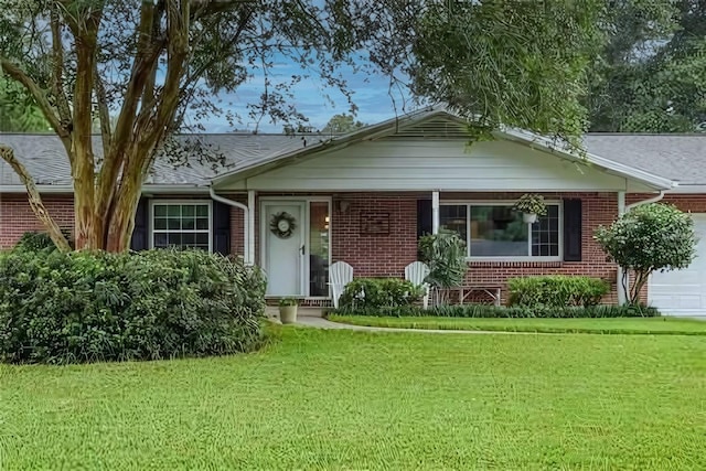 view of front of property with a garage and a front lawn