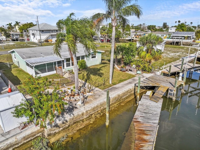 dock area with a yard and a water view