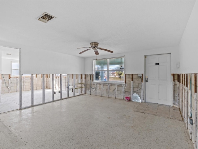 unfurnished living room featuring ceiling fan