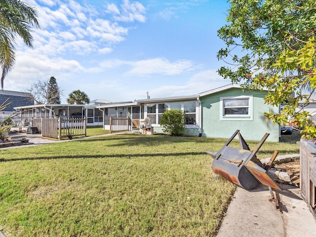 view of front of home with a sunroom and a front lawn