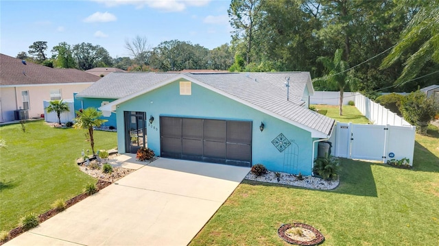 view of front facade featuring a garage, central AC, and a front lawn