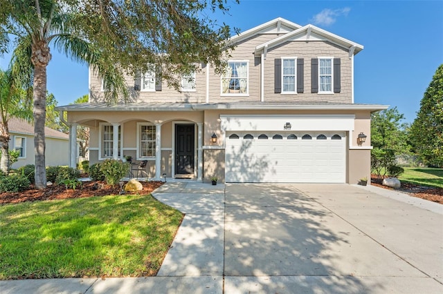 view of front of house featuring a porch, a garage, and a front yard