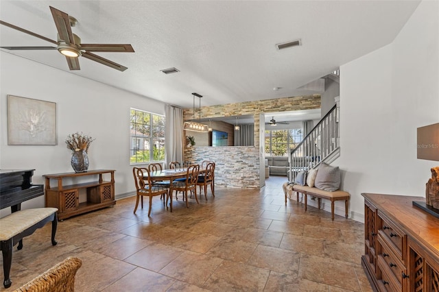 dining space with a wealth of natural light, a textured ceiling, and ceiling fan