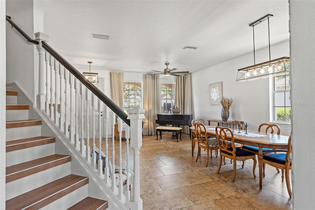 dining room with ceiling fan, a textured ceiling, and a healthy amount of sunlight