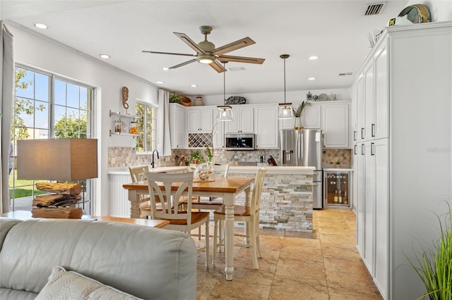 dining room featuring ceiling fan and sink