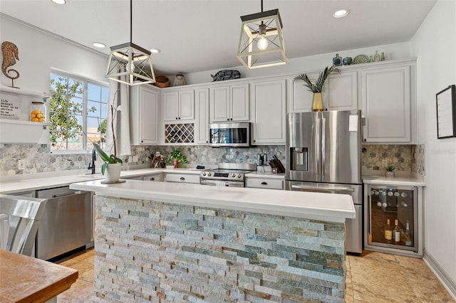 kitchen featuring pendant lighting, white cabinetry, wine cooler, backsplash, and stainless steel appliances