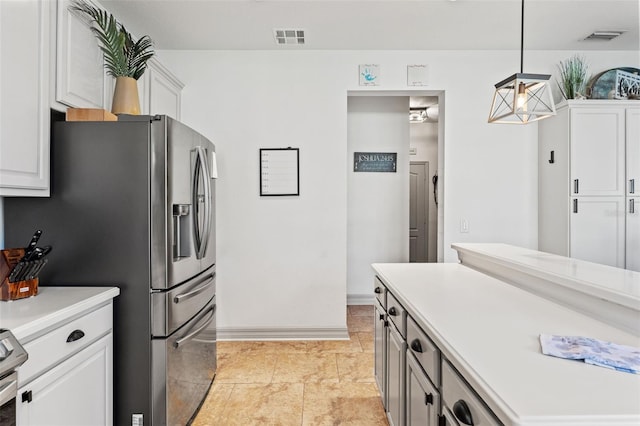 kitchen with pendant lighting, white cabinetry, and stainless steel refrigerator with ice dispenser