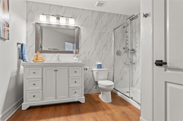 bathroom featuring an enclosed shower, vanity, hardwood / wood-style floors, and toilet