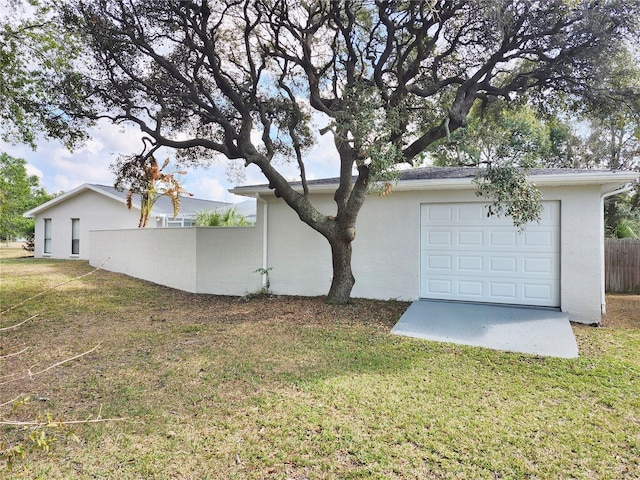 exterior space featuring a garage and a yard