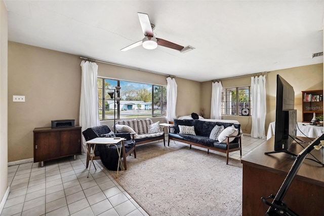 living room featuring a healthy amount of sunlight, ceiling fan, visible vents, and light tile patterned flooring