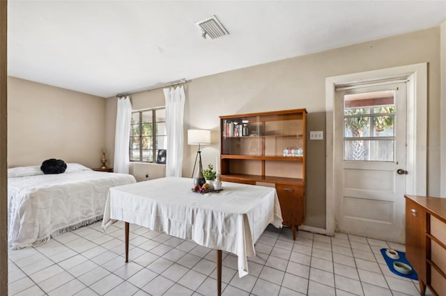 bedroom with light tile patterned floors, multiple windows, and visible vents