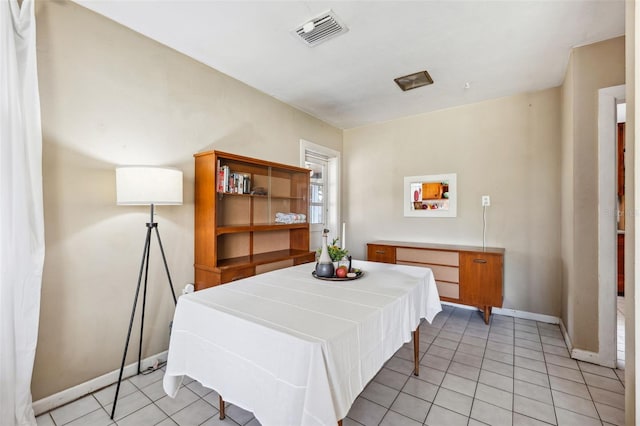 dining area with light tile patterned floors, baseboards, and visible vents