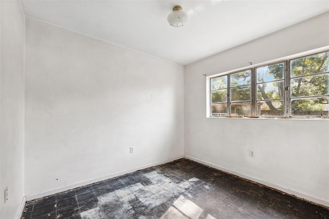 unfurnished room featuring baseboards