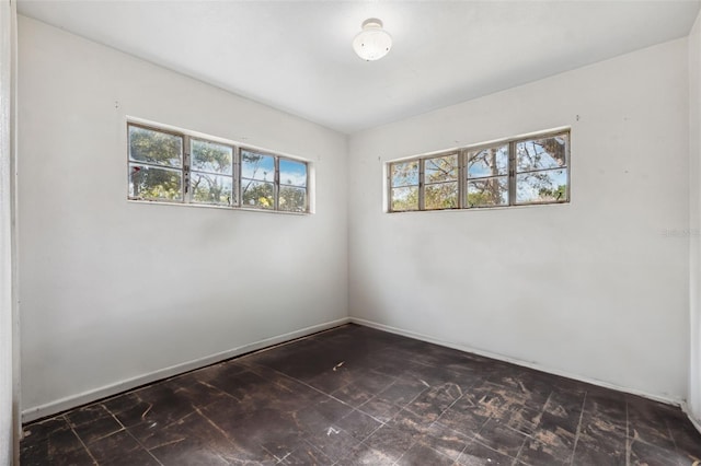 spare room featuring baseboards