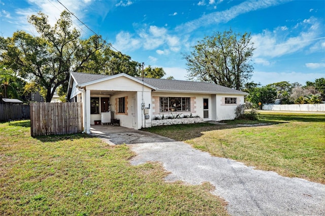 single story home featuring fence and a front lawn